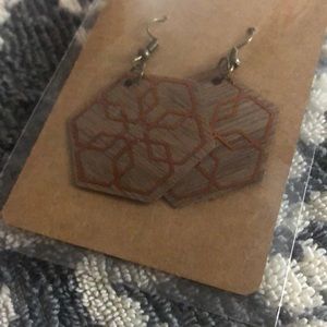 Homemade wooden earrings. Snowflake copper